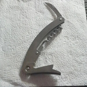 Multi wine and bottle opener..stainless steel..never used..hypoallergenic..we bu